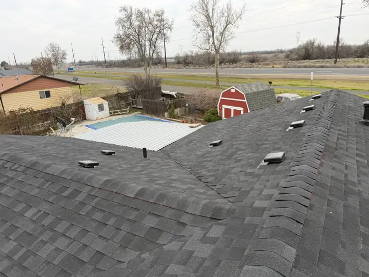 Finished architectural shingle roof with new roof vents