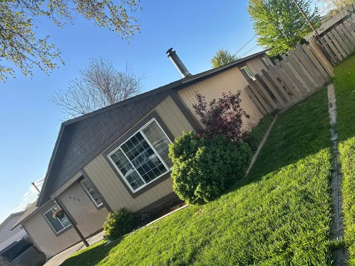 Home with new roof, yard view