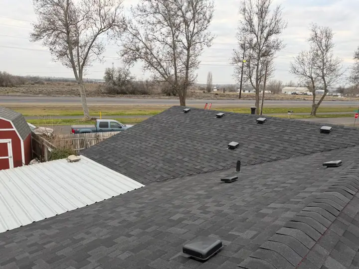 Shingle roof installed next to a metal patio cover